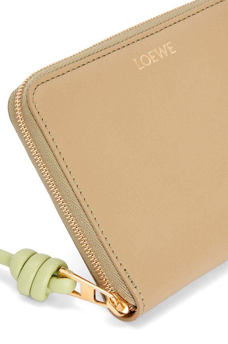 Knot compact zip around wallet in shiny nappa calfskin