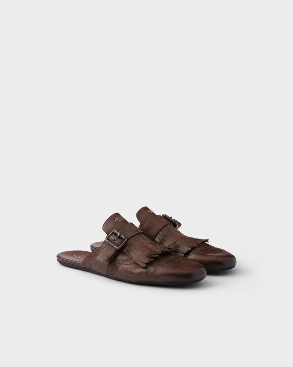 Shuffle Antiqued Leather Mules With Buckled Strap And Fringe