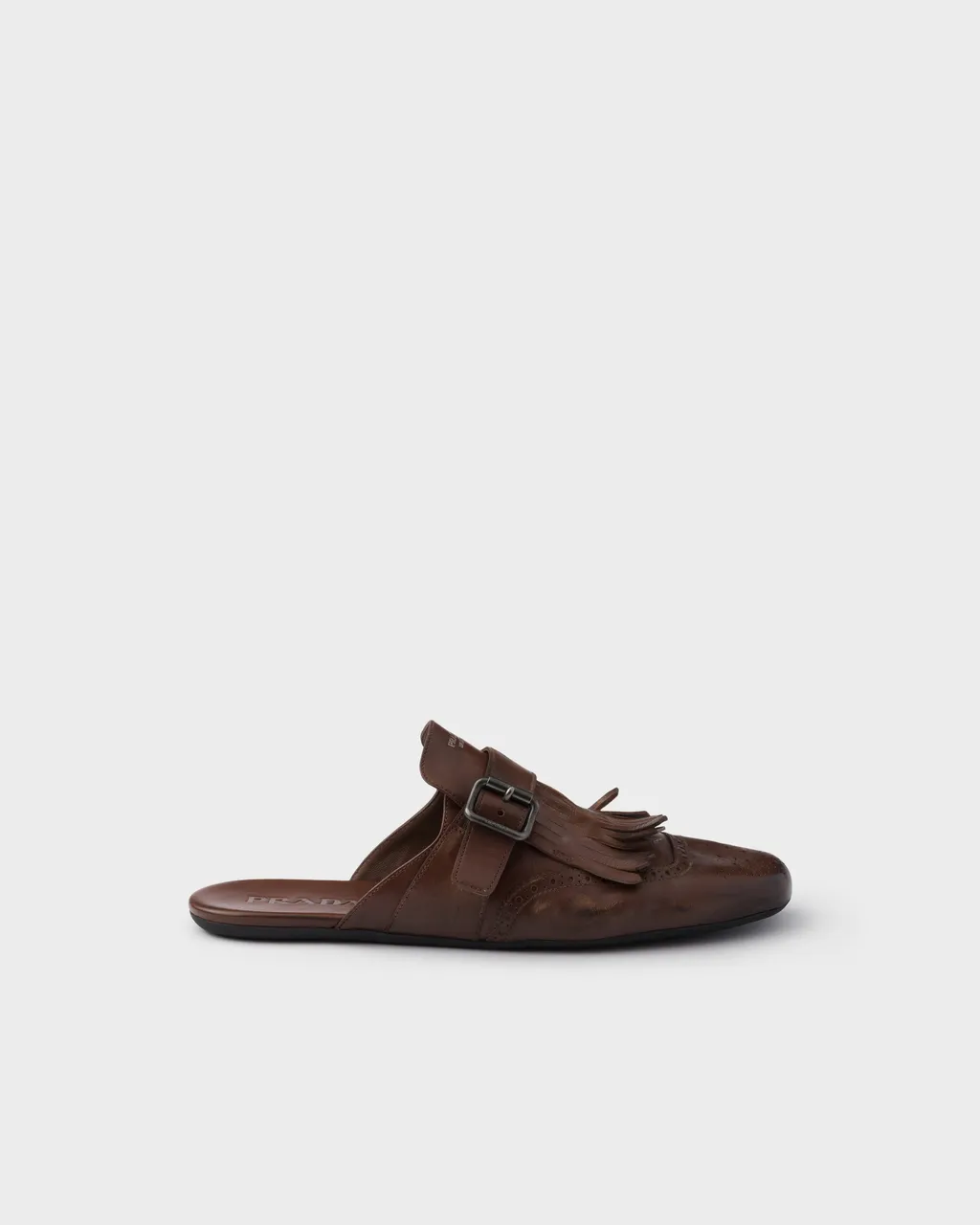 Shuffle Antiqued Leather Mules With Buckled Strap And Fringe
