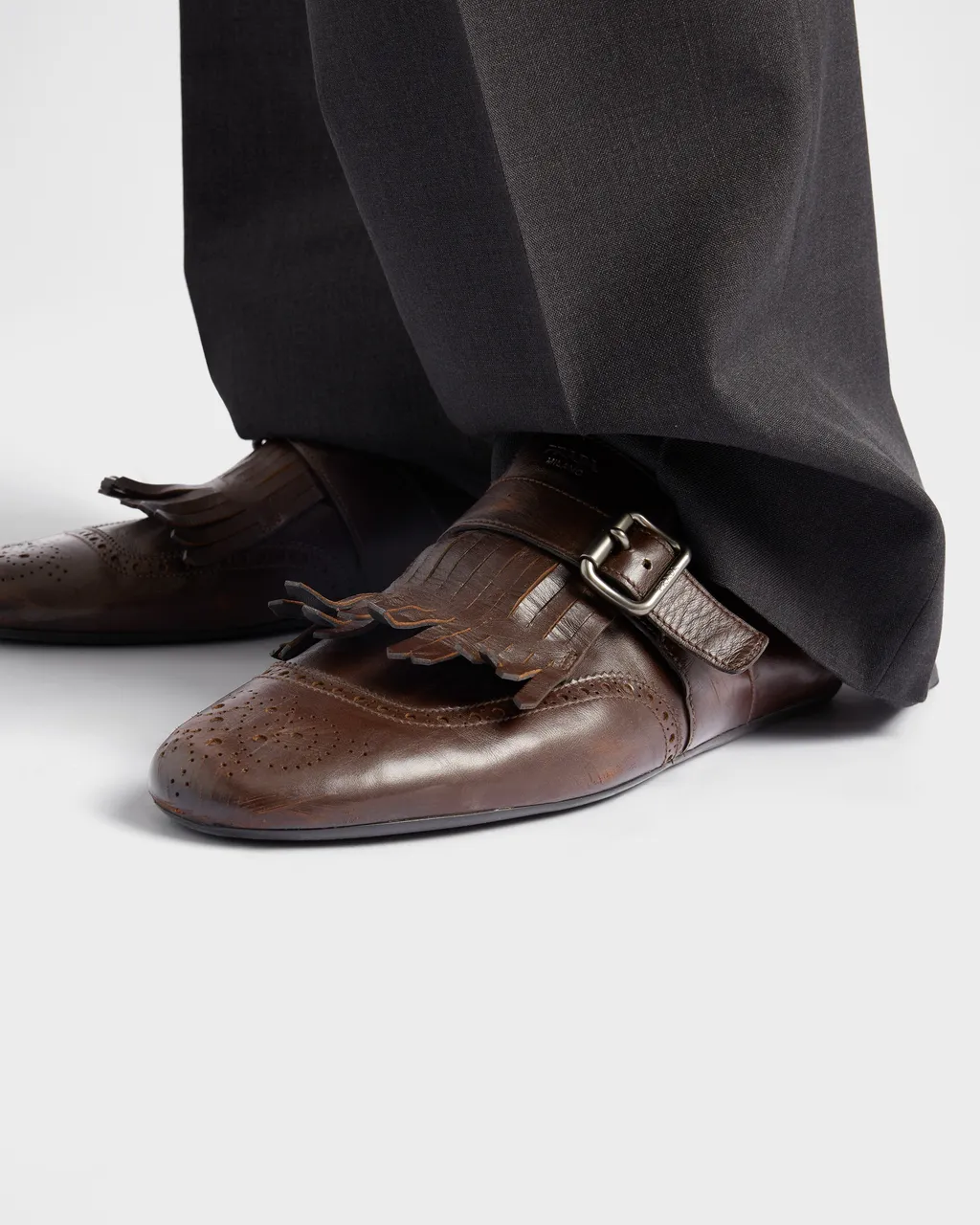 Shuffle Antiqued Leather Mules With Buckled Strap And Fringe