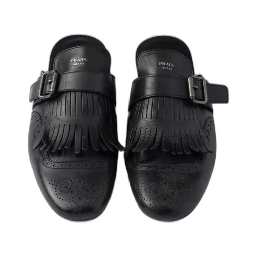 Shuffle Antiqued Leather Mules With Buckled Strap And Fringe
