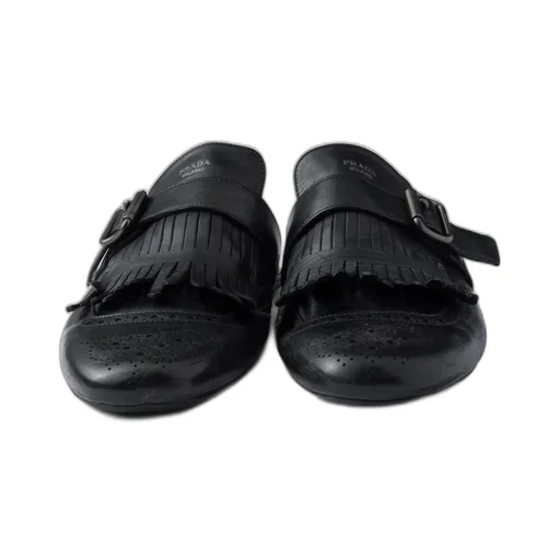 Shuffle Antiqued Leather Mules With Buckled Strap And Fringe