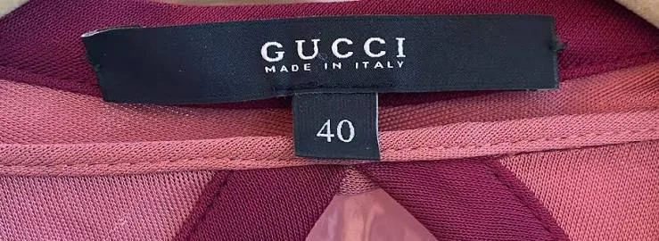 Black Gucci neck label reading GUCCI above MADE IN ITALY, with a separate size tab reading 40 below it