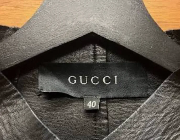 Black Gucci neck label reading GUCCI only, with a separate size tab reading 40 below it